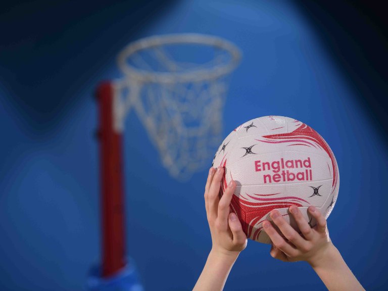 Chris Vaughan Photography - commercial photography | A close up of someone holding a netball with the words England Netball on the ball.