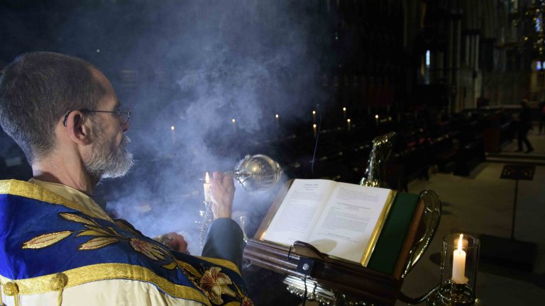 Chris Vaughan - case study images: Lincoln Cathedral | The Chancellor shakes incense over the bible.