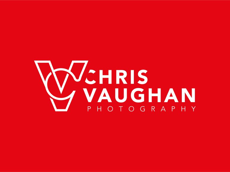 The Chris Vaughan Photography logo in white against a red background. The Chris Vaughan Photography icon logo in white against a red background. The logo features the letters C and V intertwined and the centre forms a camera aperture shape, with the words Chris Vaughan Photography next to it..