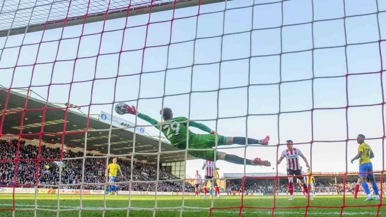 Chris Vaughan Photography - Sports images | Lincoln City goalkeeper Jordan Wright makes a full-length diving save.