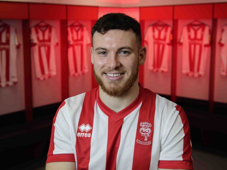 Chris Vaughan Photography - case study: Lincoln City | Lincoln City's Ben House poses for a photograph in the club's changing room after signing with the Imps.