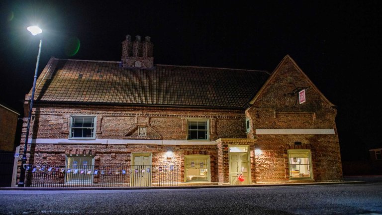 A night-time exterior image of the refurbished Old Kings Head.