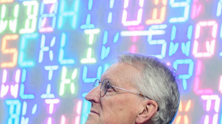 Chris Vaughan - case study images: MathsCity | MP Hillary Benn sat in front of a coding wall.